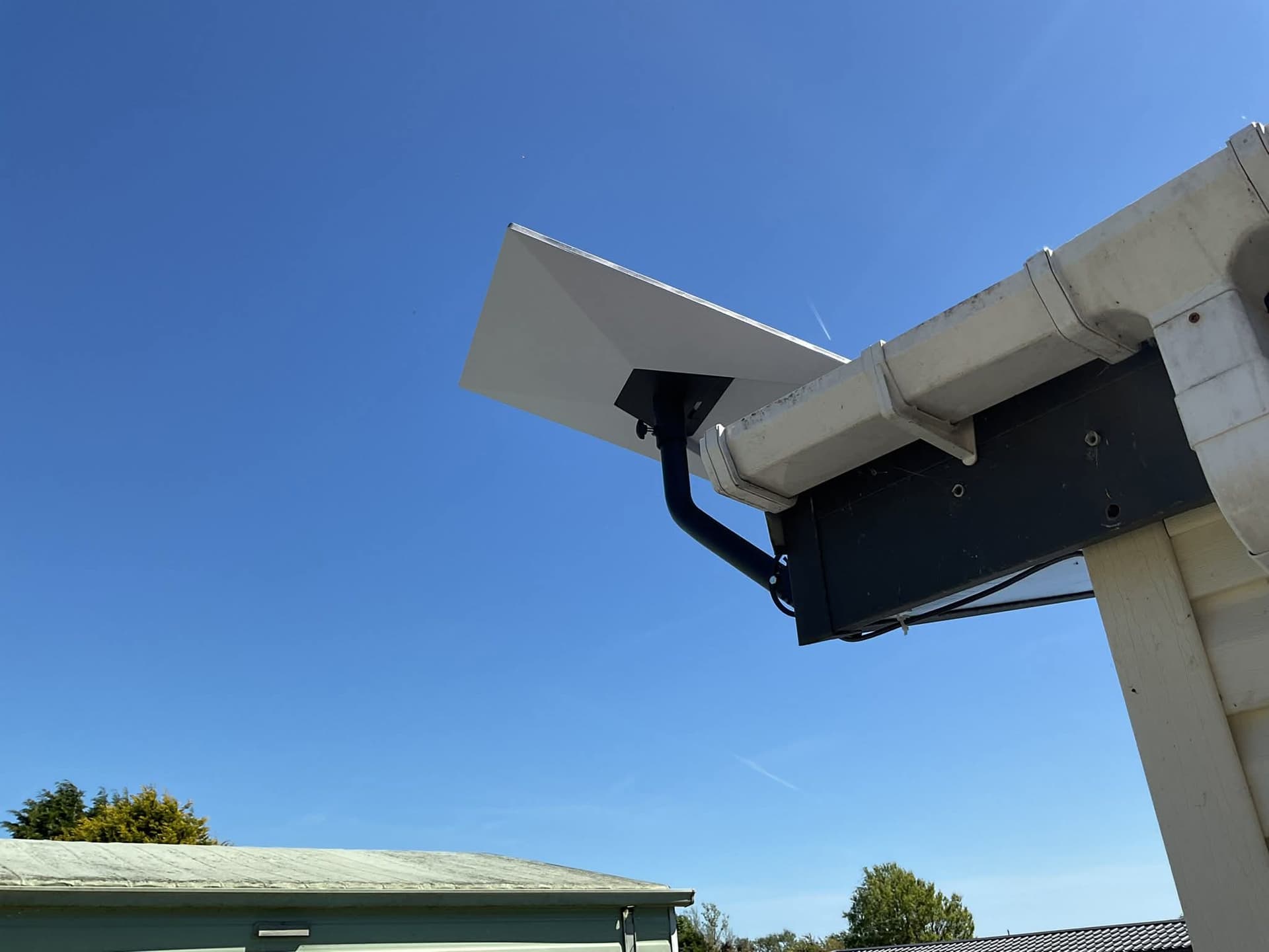 Starlink roof installation raised clear against a wide blue sky